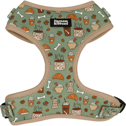 Dog harness with a pattern of coffee cups, croissants, and bones on a green background.