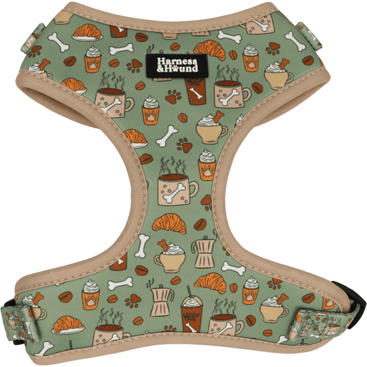 Dog harness with a pattern of coffee cups, croissants, and bones on a green background.